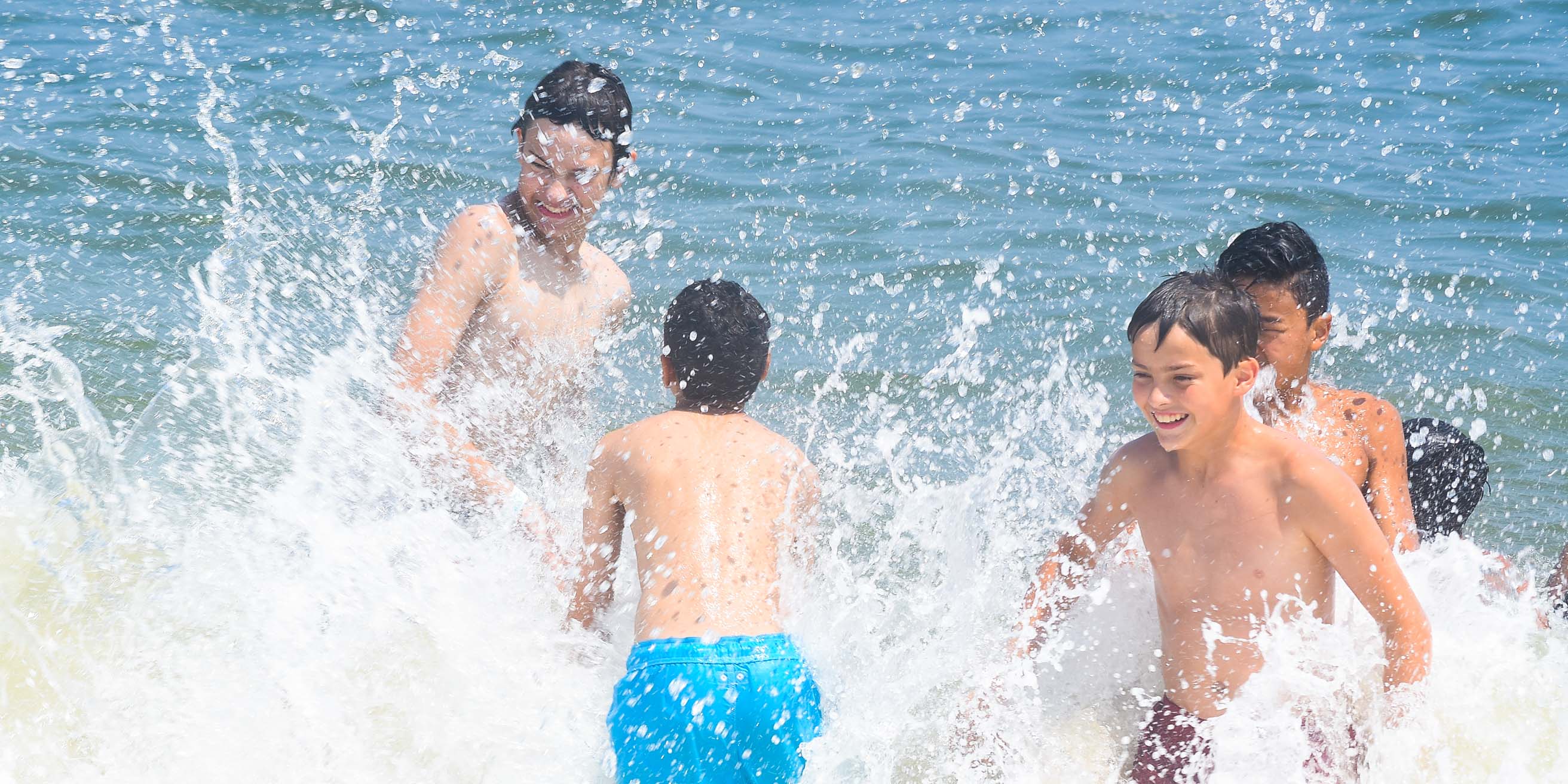 Campers at the beach splashing