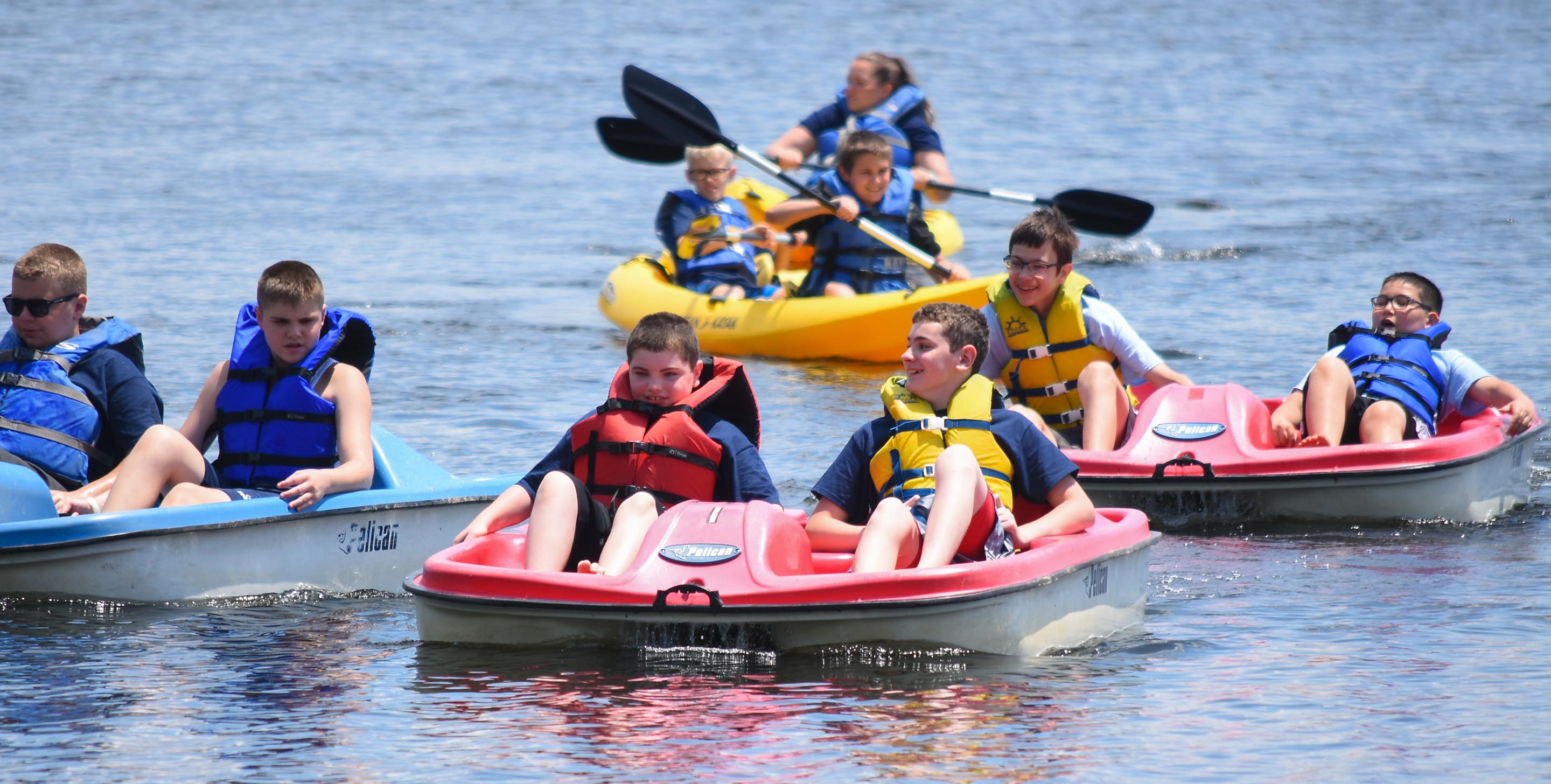 Boys on boats on the pond
