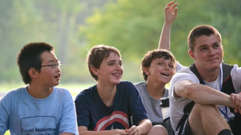 Boys outside by campfire