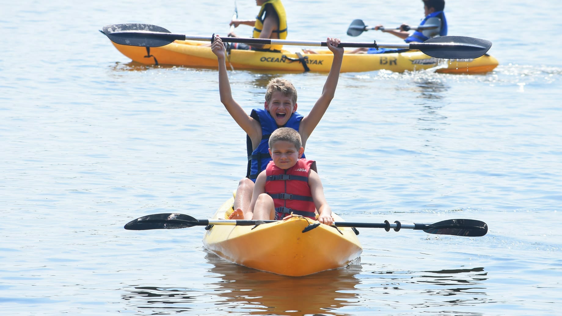 Campers kayaking on a lake