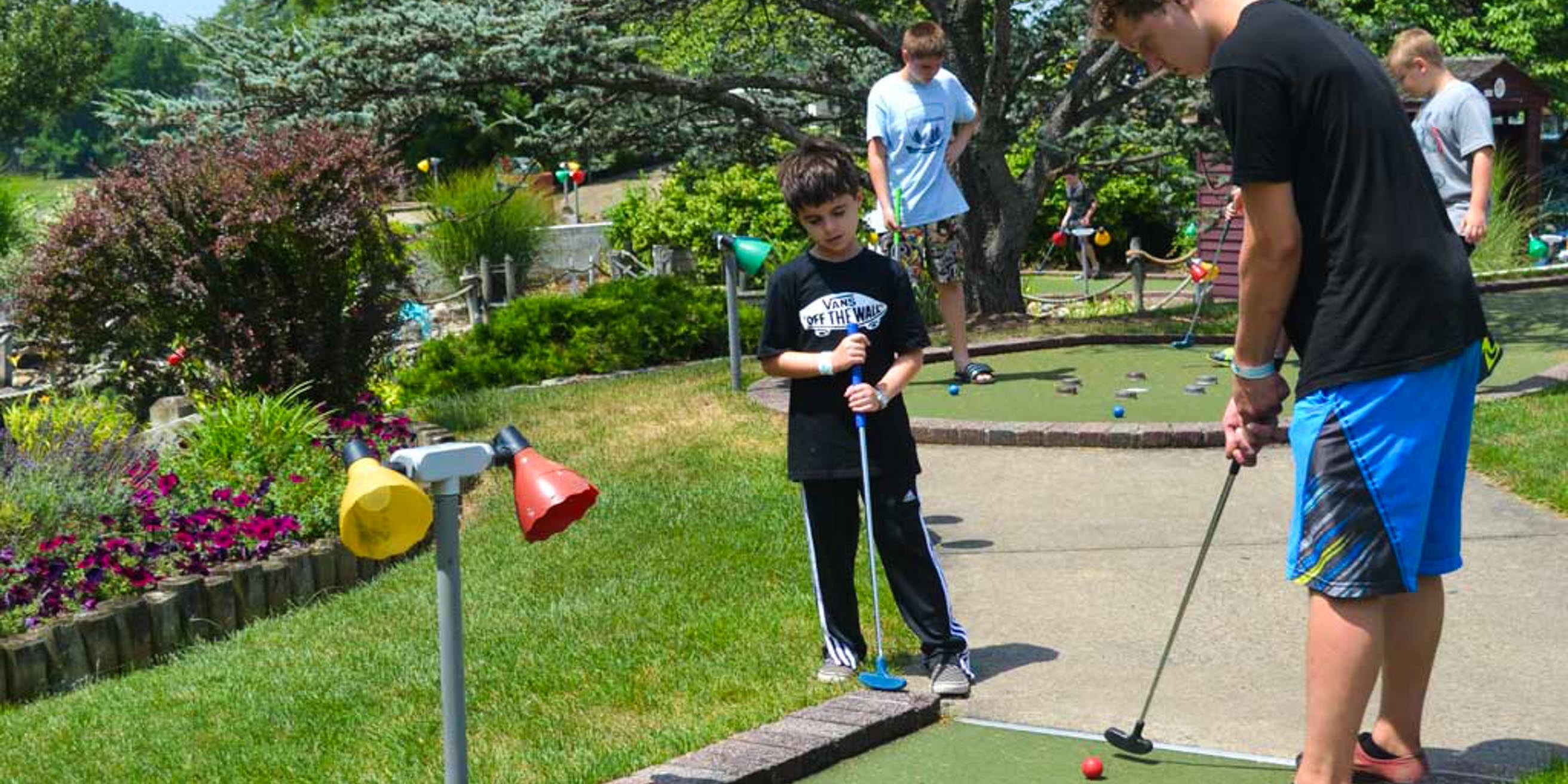 Campers and staff playing mini-golf