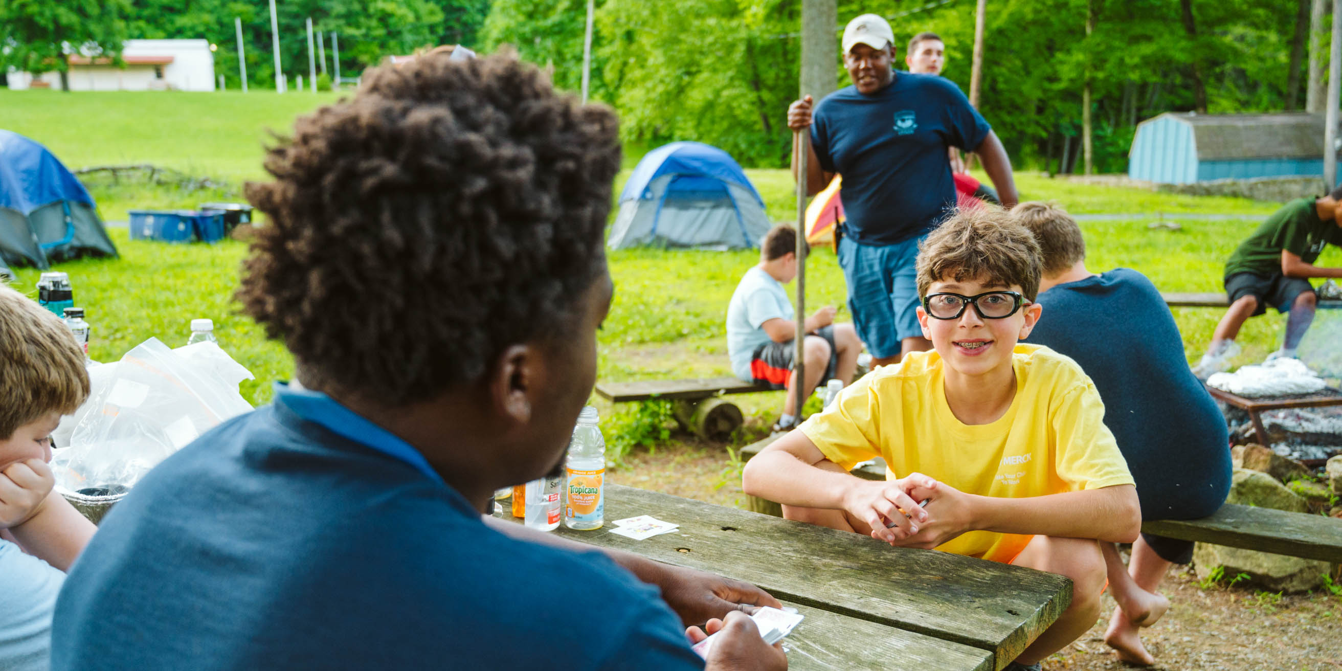 Campers playing a game of Magic on a Rustic Overnight Retreat