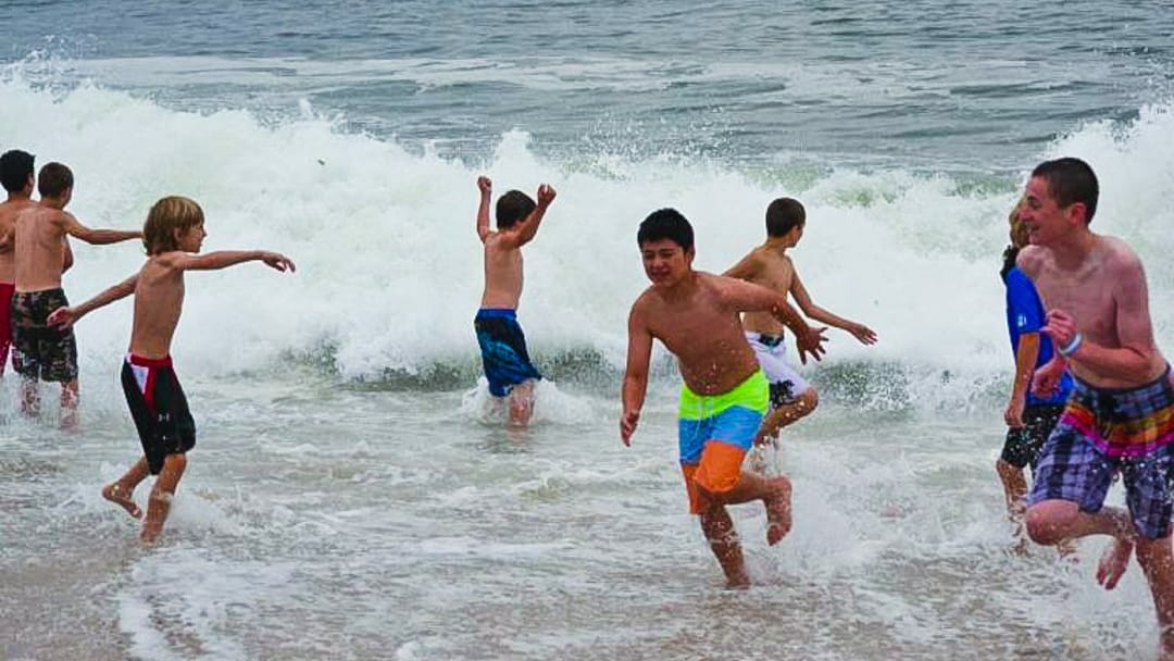 Running on the beach at a school year trip