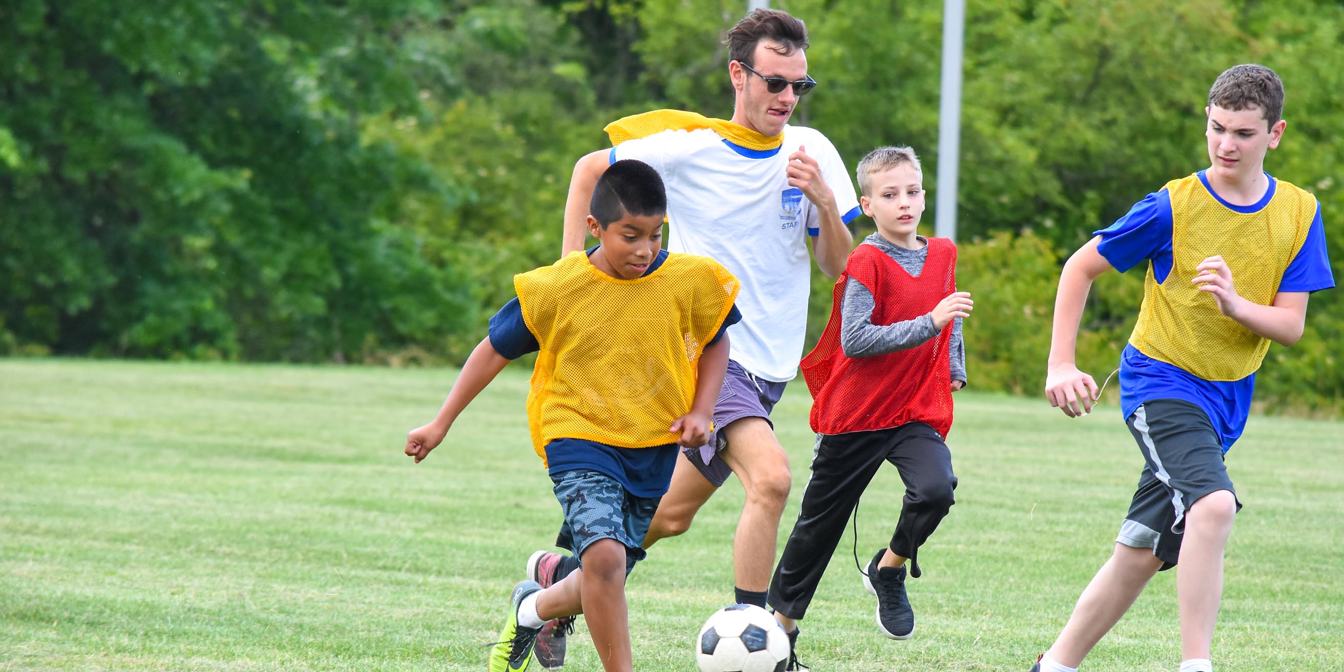 Boys and staff playing soccer