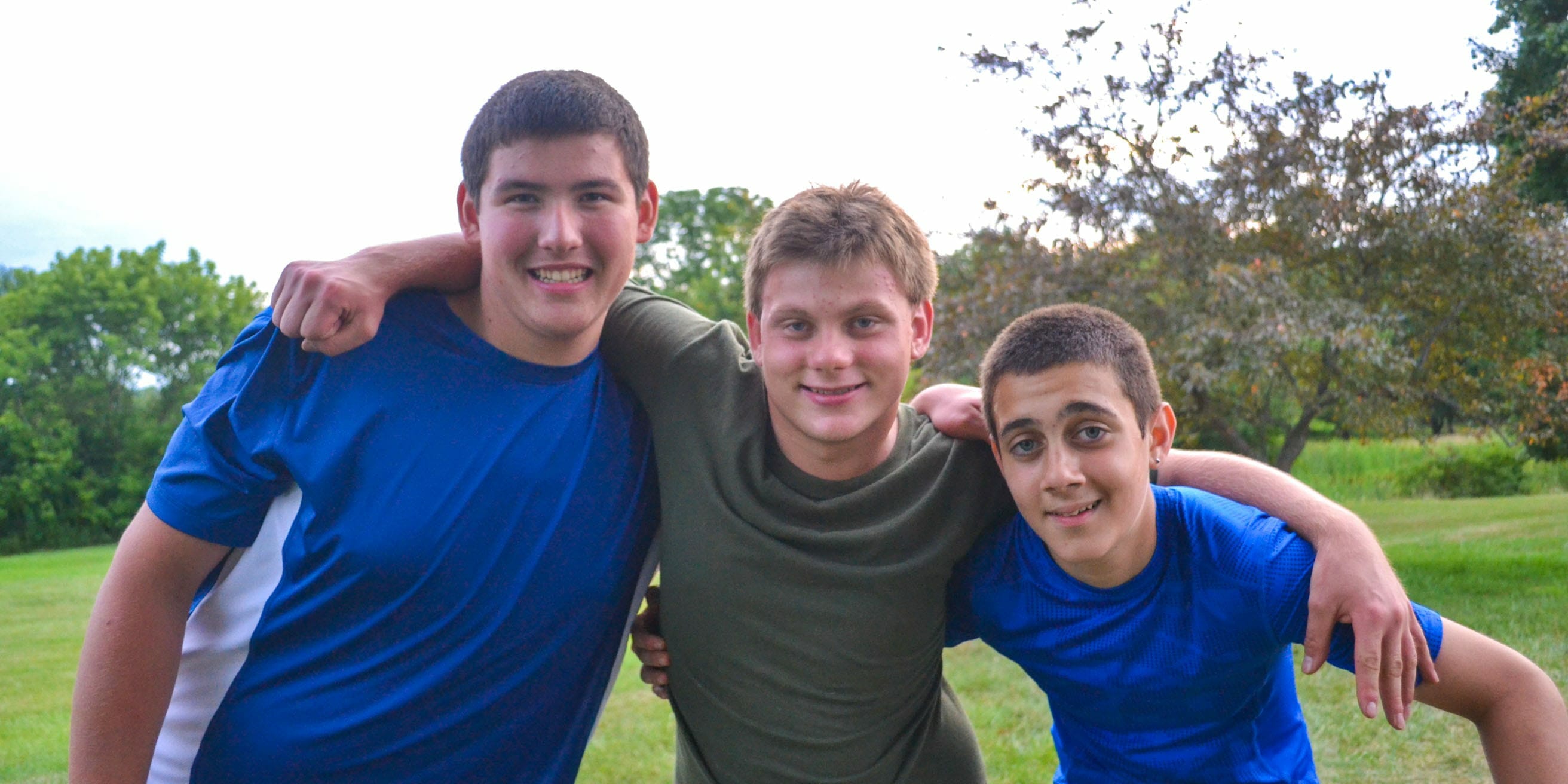 Three boys smiling